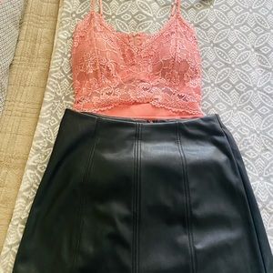 Two pink shirts and a leather skirt